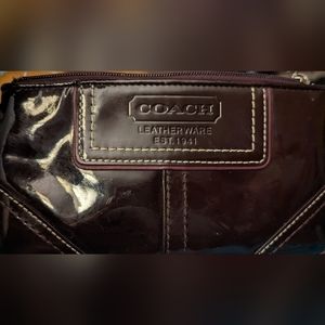 EUC Coach maroon patent leather wristlet zip top black cloth interior, charm